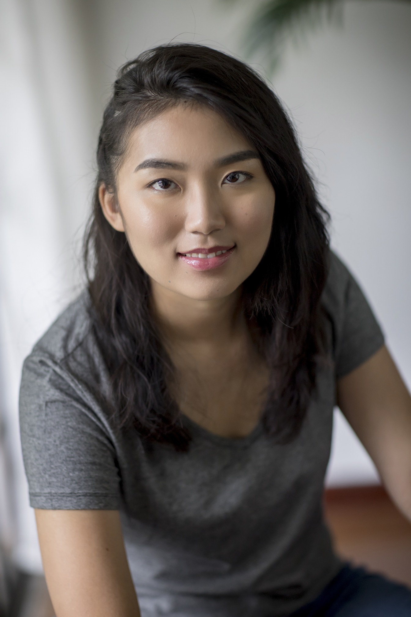 The author wearing a grey t-shirt in front of a white background, leaning forward with their left shoulder tilted toward the viewer.