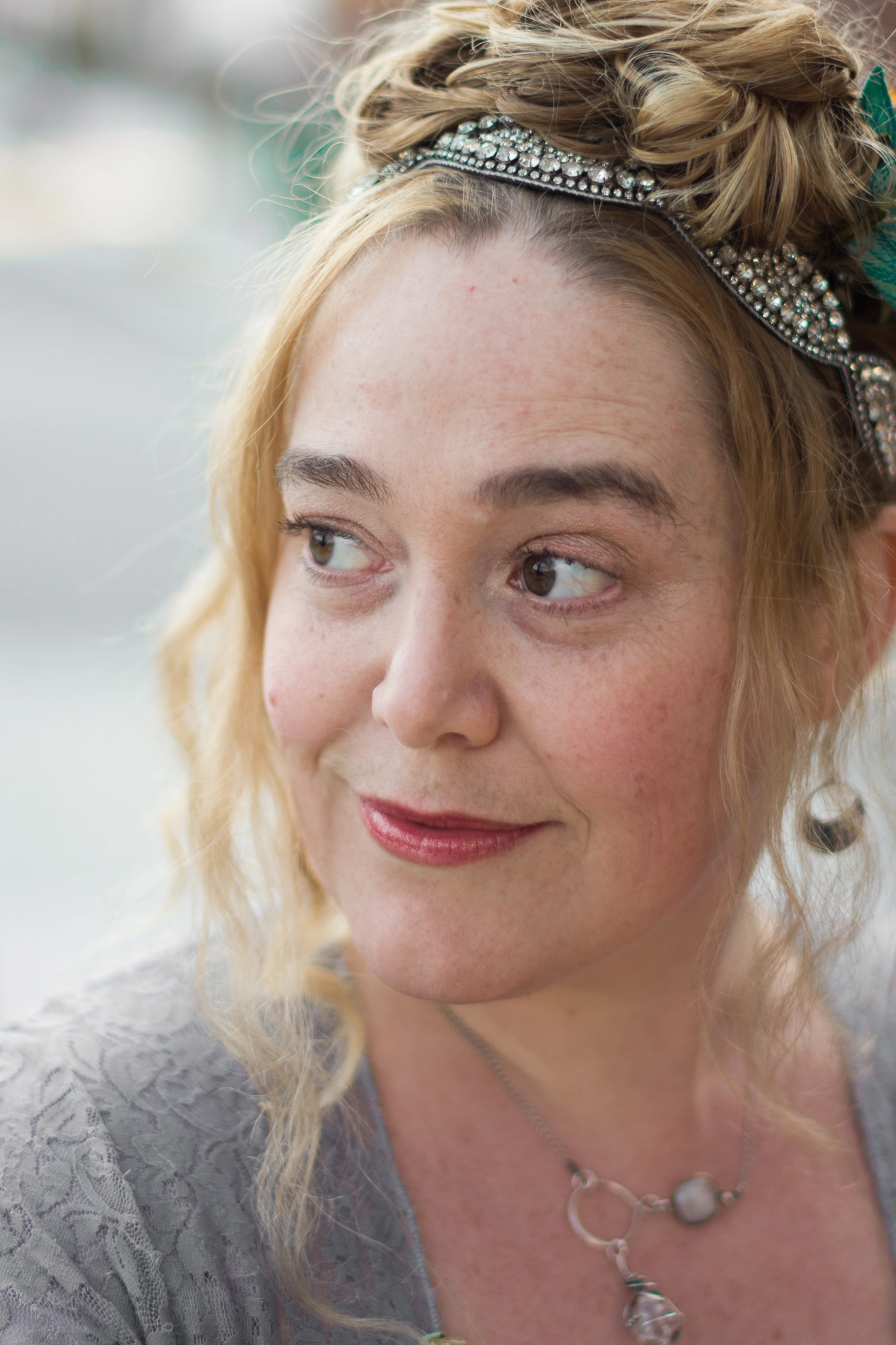 A headshot of the author with her hair up in loose curls, looking toward her right.